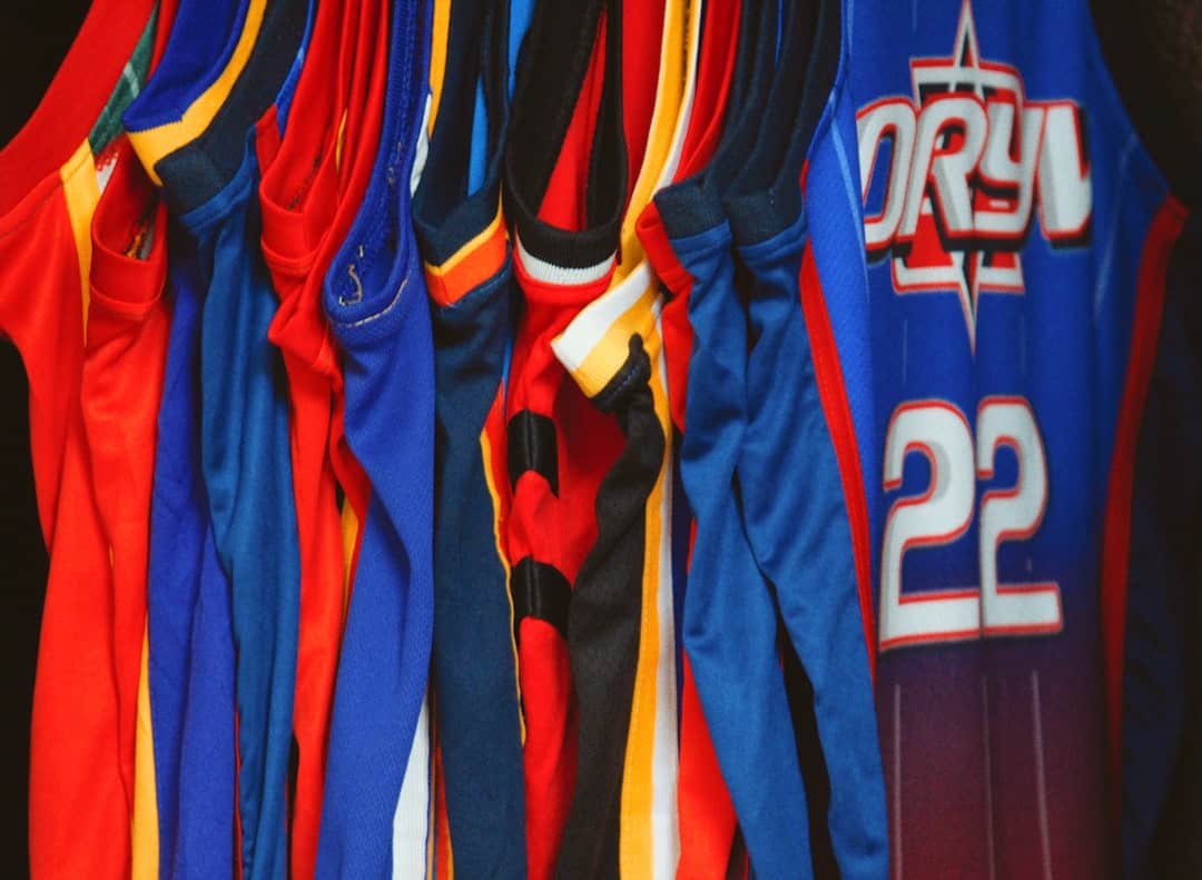 custom-sports-apparel-image Colorful San Marcos custom apparel with sports jerseys hanging in a row.
